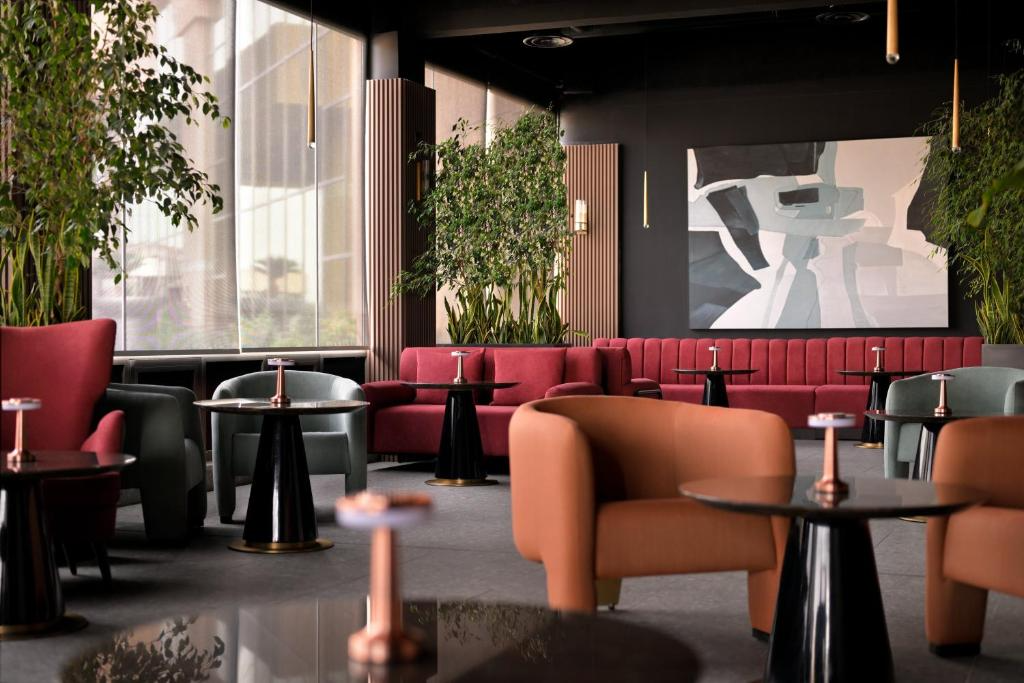 freepik__photo-a-modern-lounge-area-with-plush-red-sofas-or__48924